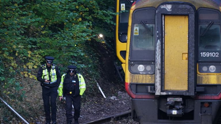 Police officers at the scene of a crash involving two trains near the Fisherton Tunnel between Andover and Salisbury in Wiltshire. Fifty firefighters were called to the scene of the collision in which up to a dozen passengers are believed to have been injured. Picture date: Monday November 1, 2021.

