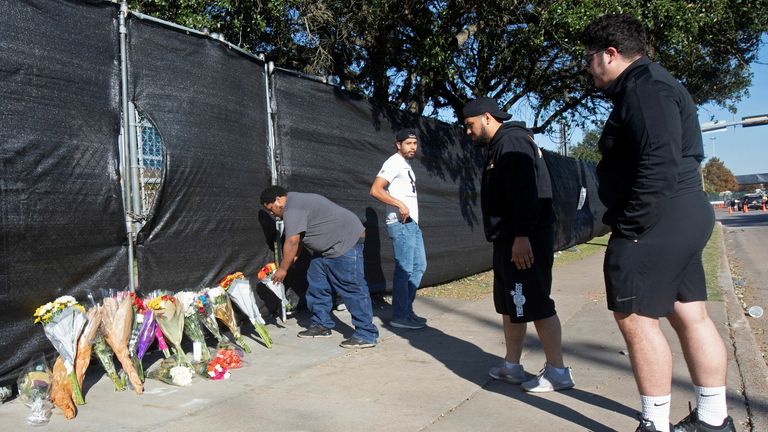 Matthew Shelton, Diego Rivera, Anthony Perez et Juan Carillo déposent des fleurs sur une porte de NRG Park, après un écrasement mortel de fans lors d'une performance la veille au Astroworld Festival du rappeur Travis Scott à Houston, Texas, États-Unis, le 6 novembre 2021 REUTERS/Daniel Kramer