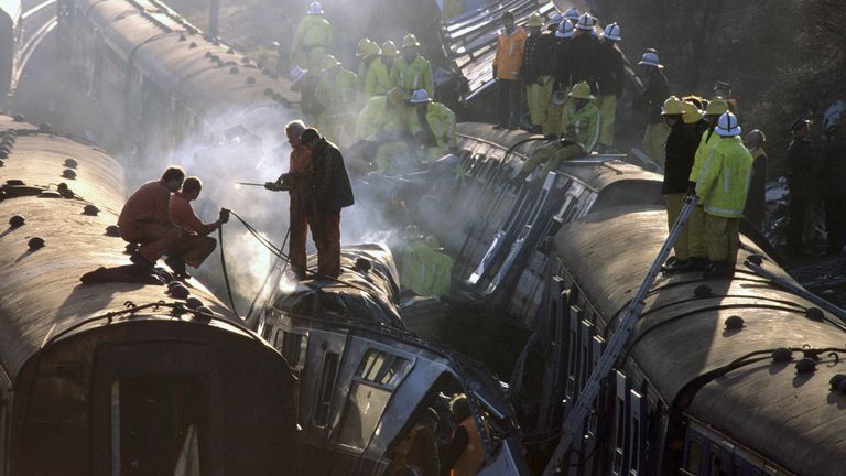 Rescue workers clamber over the wreckage of three trains that crashed near Clapham Junction, London, to help injured passengers following a multiple train crash in which 35 people were killed and 500 were injured when a crowded passenger train crashed into the rear of another train that had stopped at a signal, and an empty train, travelling in the other direction, crashed into the debris.