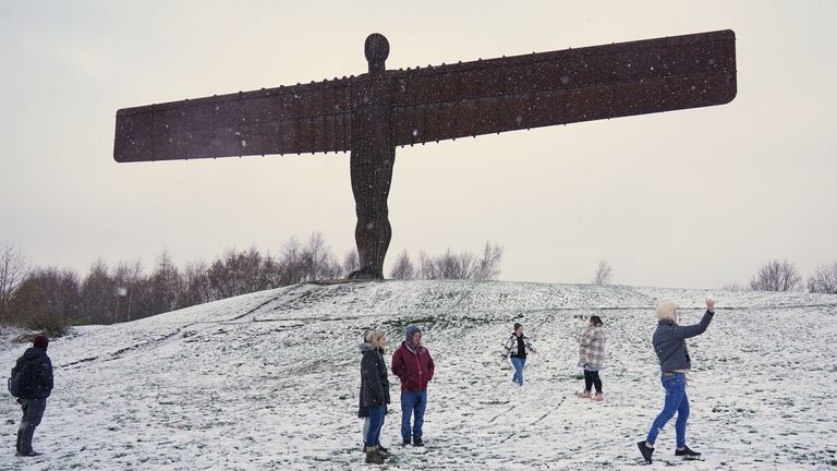 People at a snow covered Angel of the North in Gateshead