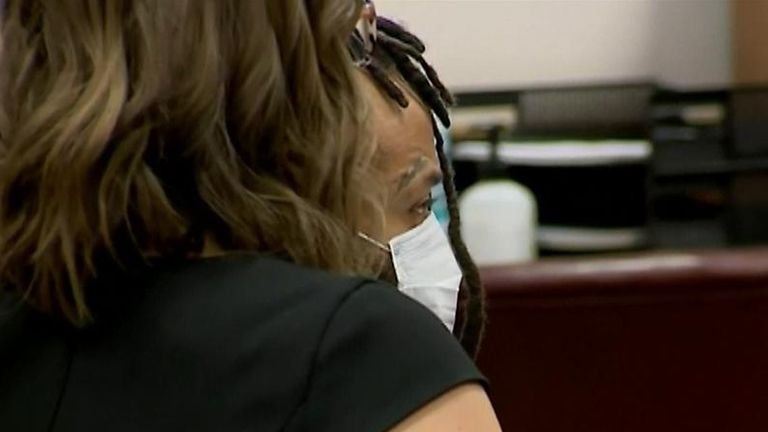 Darrell Brooks in court partially obscured from the camera by his lawyer