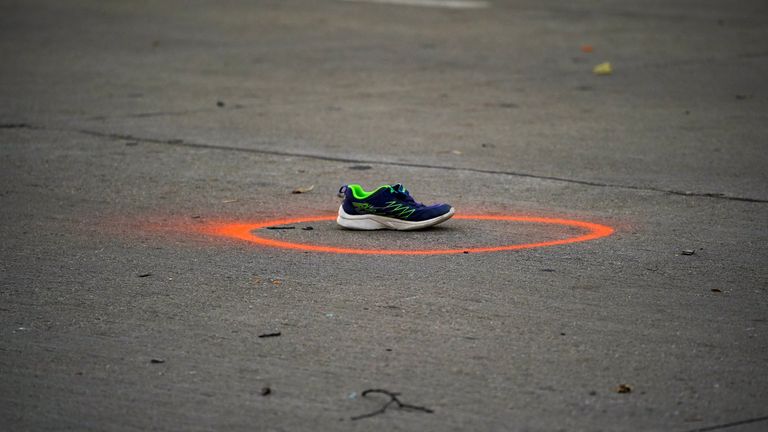 A shoe circled in spray paint to mark as evidence are seen on Main Street the morning after a car plowed through a holiday parade in Waukesha, Wisconsin, U.S., November 22, 2021. REUTERS/Cheney Orr

