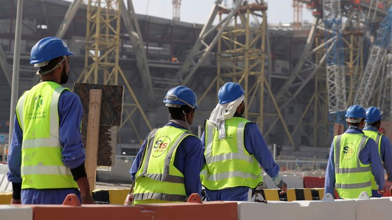 Workers walk to the Lusail Stadium. Pic: AP