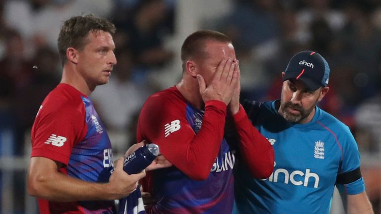 England&#39;s Jos Buttler (L) looks on as opening partner Jason Roy is helped off the field after pulling up during the T20 World Cup match against South Africa (Associated Press)