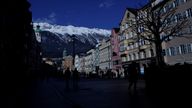 People walk down a shopping street as shops are closed due to the fourth national coronavirus disease (COVID-19) lockdown in Innsbruck, Austria, December 1, 2021. REUTERS/Leonhard Foeger