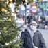 A woman wears a mask as she walks past Christmas decorations in London's Knightbridge - one of the UK capital's prime residential and retail areas. Picture date: Thursday December 2, 2021.