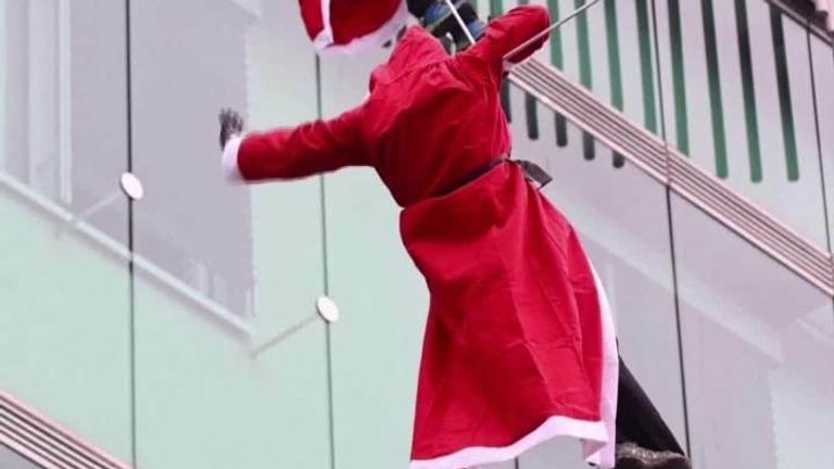 Climbers dressed as Santa Claus abseiled down the outside of a Ljubljana children&#39;s hospital to spread Christmas cheer. 