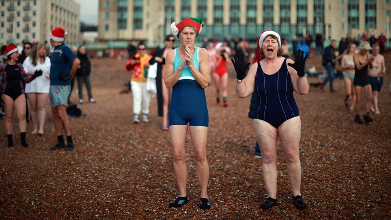 People prepare to enter the sea during a Christmas Day dip on Brighton beach in southern England, Britain, December 25, 2021. REUTERS/Hannah McKay

