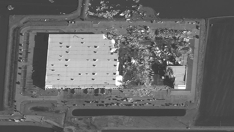 A close up satellite view of the Amazon warehouse in Illinois that a tornado carved a gash in the roof. Pic: Maxar Technologies