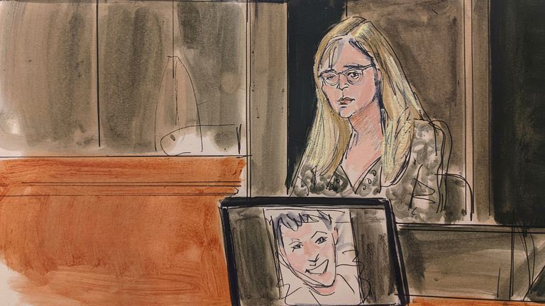 In this courtroom sketch, Annie Farmer testifies on the witness stand during the Ghislaine Maxwell sex abuse trial, Friday, Dec. 10, 2021, in New York. A photo of Maxwell appears on a screen at foreground.(Elizabeth Williams via AP)
