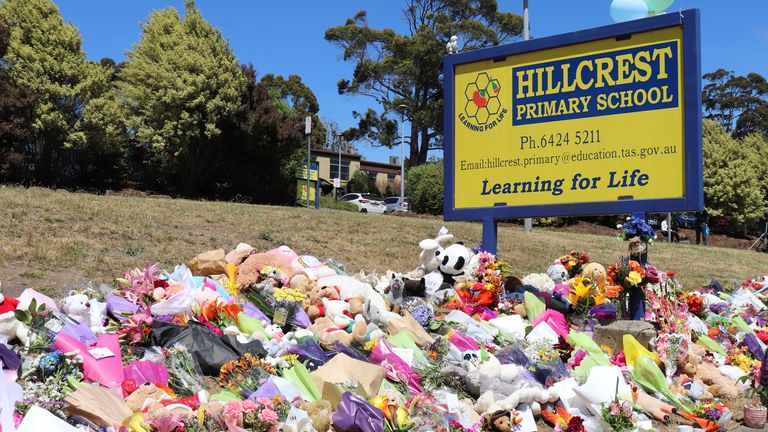 Flowers and tributes are seen outside Hillcrest Primary School in Devonport, Tasmania, Friday, December 17, 2021. The death toll from a freak jumping castle accident at a primary school in Tasmania&#39;s northwest remains at five, and three children are in hospital after one was allowed to go home.  
PIC:AAP/AP