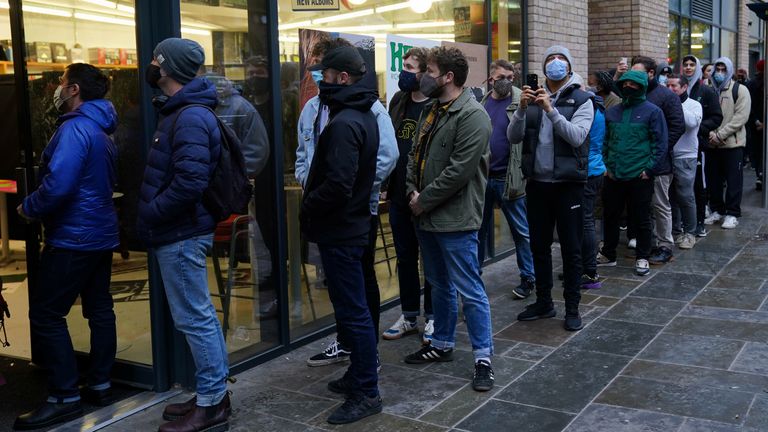 People queue outside Rough Trade in Bristol, where a t-shirt designed by street artist Banksy is being sold