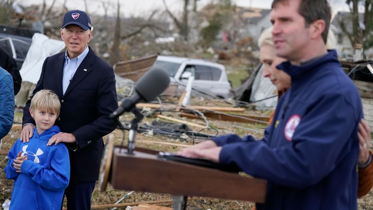 President Joe Biden listens as Kentucky Gov. Andy Beshear speaks after surveying storm damage from tornadoes and extreme weather in Dawson Springs, Ky., Wednesday, Dec. 15, 2021. Britainy Beshear is at right. (AP Photo/Andrew Harnik)