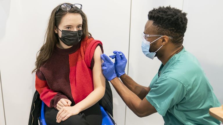 PABest Associate Practitioner Alex Iheanacho (right) administers a booster coronavirus vaccine to Shona McCauley (left) at a Covid vaccination centre at Elland Road in Leeds, as the booster vaccination programme continues across the UK. Picture date: Tuesday December 21, 2021.

