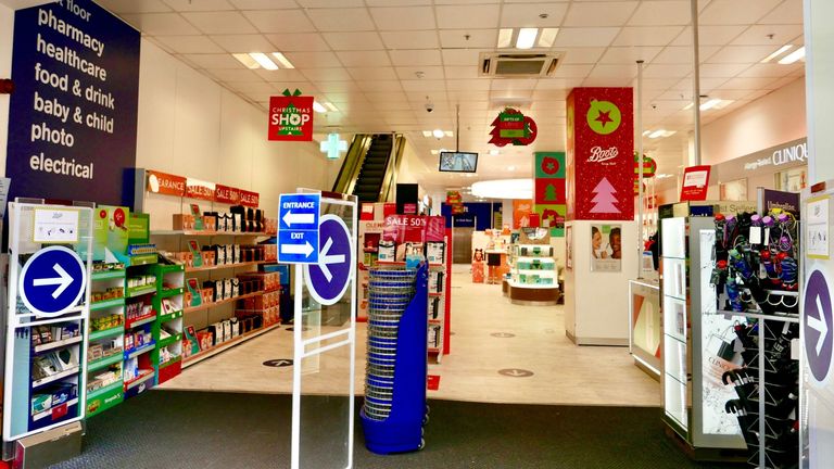 Entrance interior of Boots chemist & pharmacy shop on Oxford Street, London. No customers present. One way directional signs due to social distancing - Image ID: 2E9W0PK (RM)