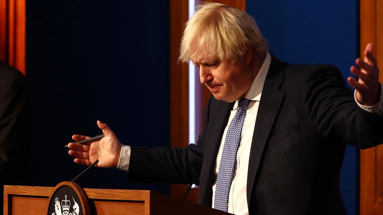 Prime Minister Boris Johnson gestures whilst speaking at a press conference in London&#39;s Downing Street after ministers met to consider imposing new restrictions in response to rising cases and the spread of the Omicron variant. Picture date: Wednesday December 8, 2021.
