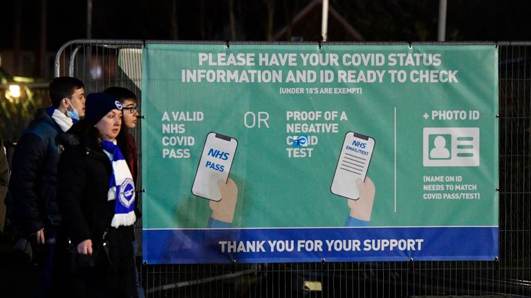 Soccer Football - Premier League - Brighton & Hove Albion v Wolverhampton Wanderers - The American Express Community Stadium, Brighton, Britain - December 15, 2021 General view of a NHS sign as fans get their coronavirus disease (COVID-19) status information checked outside the stadium before the match