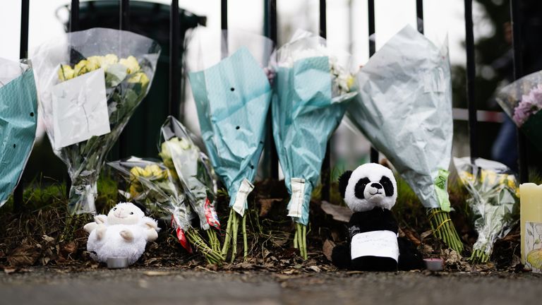 Flowers at the scene in Collingwood Road, Sutton, south London, where two sets of twin boys, aged three and four, died in a devastating house fire on Thursday. A 27-year-old woman has been arrested and held on suspicion of child neglect. Picture date: Friday December 17, 2021.
