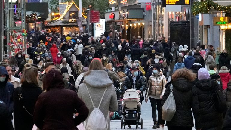 People wear mandatory face masks in a shopping street in Dortmund, Germany. Pic: AP