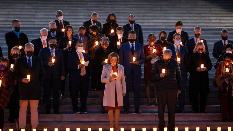 Speaker of the House Nancy Pelosi is joined by bipartisan House and Senate members to hold a moment of silence for 800,000 American lives lost to COVID-19 on the step of the Capitol. Pic: AP