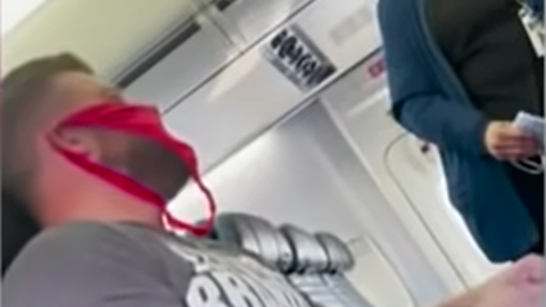  Adam Jenne,38, can be seen wearing a pink thong over his face as he sits in his seat before the flight from Fort Lauderdale to Washington took off. 