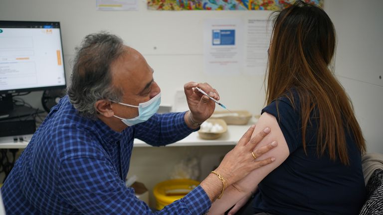 Ana Maria Dadulescu receiving her Covid booster vaccine jab at Copes Pharmacy in Streatham, south London.

