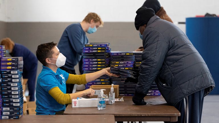 Free rapid at-home COVID testing kits are distributed at a vaccination clinic in Philadelphia
