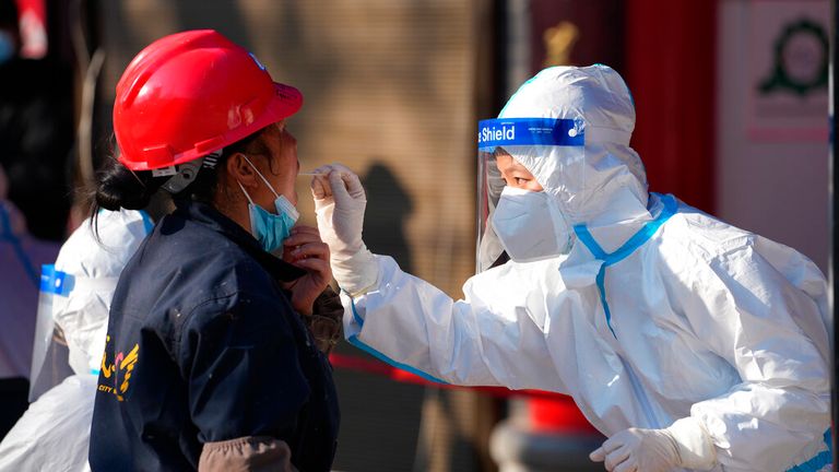 A worker wearing a protective suit collects a throat swab sample at a COVID-19 testing site in Xi&#39;an in northwestern China&#39;s Shaanxi Province. Pic: Xinhua via AP