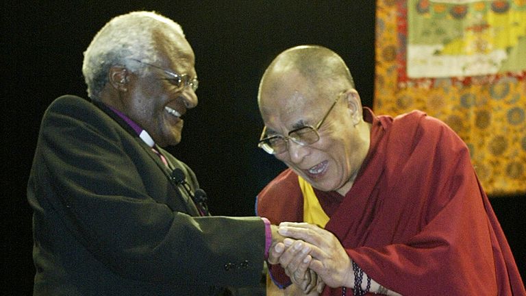FILE PHOTO: His Holiness the 14th Dalai Lama (R) greets South African Archbishop Desmond Tutu in Vancouver, British Columbia, April 18, 2004. Tenzin Gyatso, has lived in exile in India since 1959, but he is still considered by many to be both the spiritual and political leader of the Tibetan people. The Dalai Lama kicks off his 19 day tour of Canada with four days of lectures in Vancouver. REUTERS/Lyle Stafford/File Photo