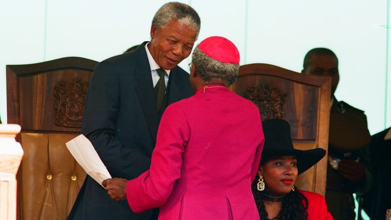 Anglican Archbishop Desmond Tutu congratulates Nelson Mandela (L), the newly sworn-in first black President of South Africa, at the Union Buildings in Pretoria, May 10, 1994. REUTERS/Peter Andrews (SOUTH AFRICA  - Tags: POLITICS)