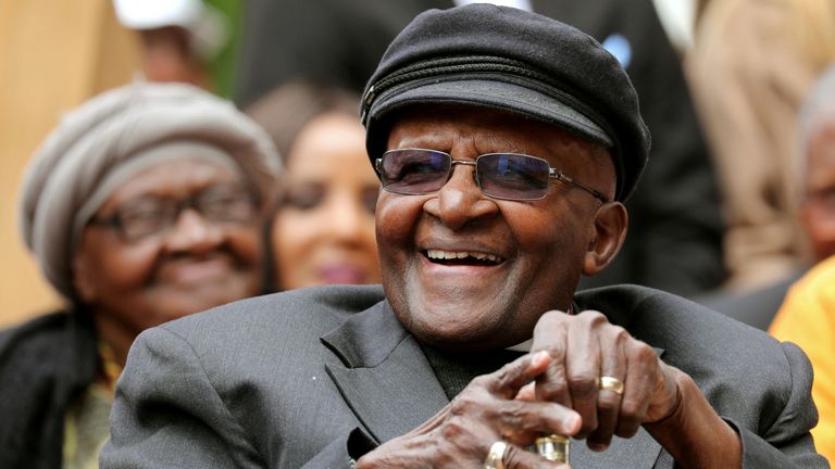 FILE PHOTO: Archbishop Desmond Tutu laughs as crowds gather to celebrate his birthday by unveiling an arch in his honour outside St George&#39;s Cathedral in Cape Town, South Africa, October 7, 2017. REUTERS/Mike Hutchings/File Photo