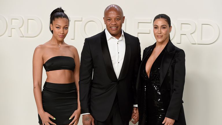 One of the last times Dr Dre and Nicole Young were pictured together, at the Tom Ford show in February 2020, with their daughter Truly (left). Pic: AP