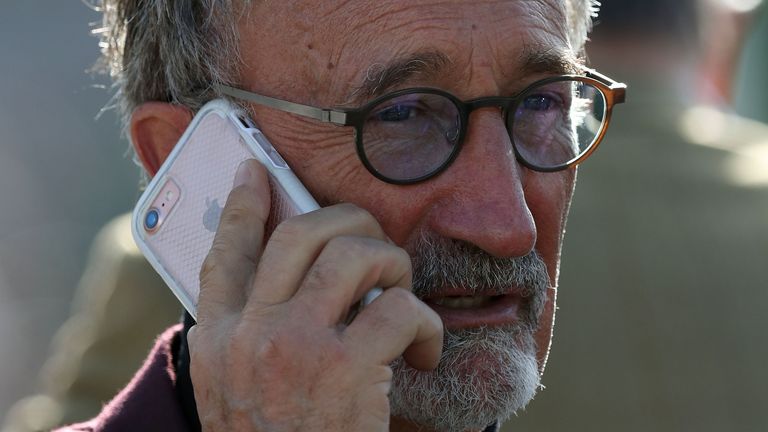 Eddie Jordan on the phone during Ladies Day of the 2017 Cheltenham Festival at Cheltenham Racecourse. PRESS ASSOCIATION Photo. Picture date: Wednesday March 15, 2017