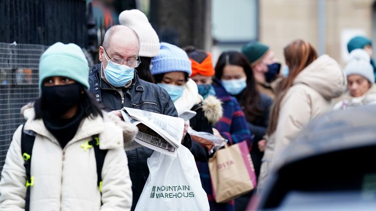 People queue along Junction Place, Edinburgh, for the vaccination centre at the NHS Scotland Leith Community Treatment Centre, as the coronavirus booster vaccination programme is ramped up to an unprecedented pace of delivery, with every eligible adult in Scotland being offered a top-up injection by the end of December. Picture date: Monday December 20, 2021.
