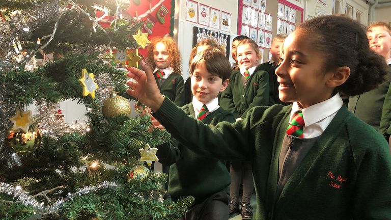 EMBARGOED TO 1600 GMT Friday December 24, 2021.   The Queen&#39;s 2021 Christmas broadcast. No further use without clearance from ITN. Handout picture of children at The Royal School, Windsor, who made 100 white and gold stars to decorate the Christmas tree that features in The Queen&#39;s Christmas Broadcast, hanging them on their school tree after the recording until the end of term when they took them home as presents for their parents and carers. Issue date: Friday December 24, 2021.