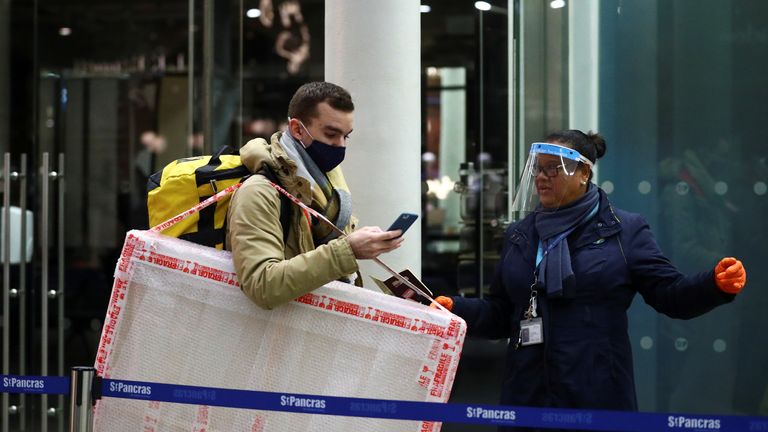 A passenger has his documents checked at the Eurostar terminal at St Pancras International, amidst the spread of the coronavirus disease (COVID-19) pandemic, in London, Britain, December 23, 2020. REUTERS/Hannah McKay