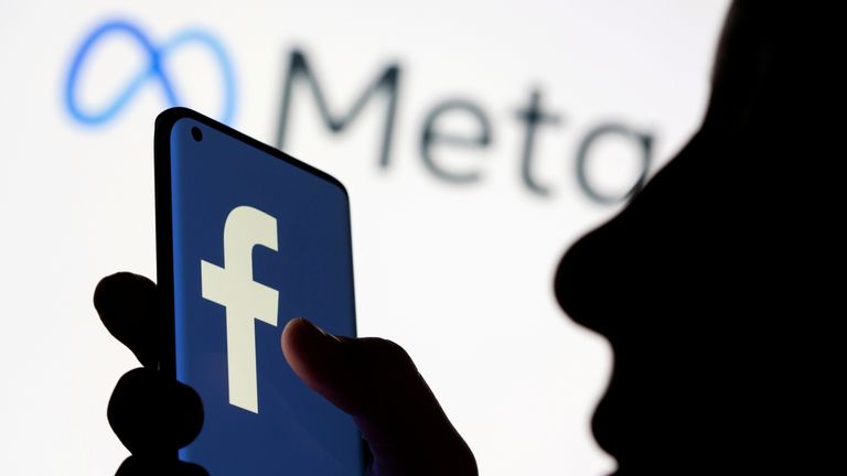 FILE PHOTO: Woman holds smartphone with Facebook logo in front of a displayed Facebook&#39;s new rebrand logo Meta in this illustration picture taken October 28, 2021. REUTERS/Dado Ruvic/Illustration/File Photo
