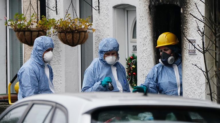 Forensic investigators at the scene in Collingwood Road, Sutton, south London, where two sets of twin boys, aged three and four, died in a devastating house fire on Thursday. A 27-year-old woman has been arrested and held on suspicion of child neglect. Picture date: Friday December 17, 2021.

