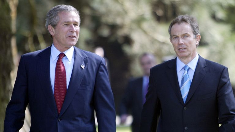 U.S. President George W. Bush (L) walks alongside Britain's Prime Minister Tony Blair inside the grounds of Hillsborough Castle, County Down, Northern Ireland, April 8, 2003.