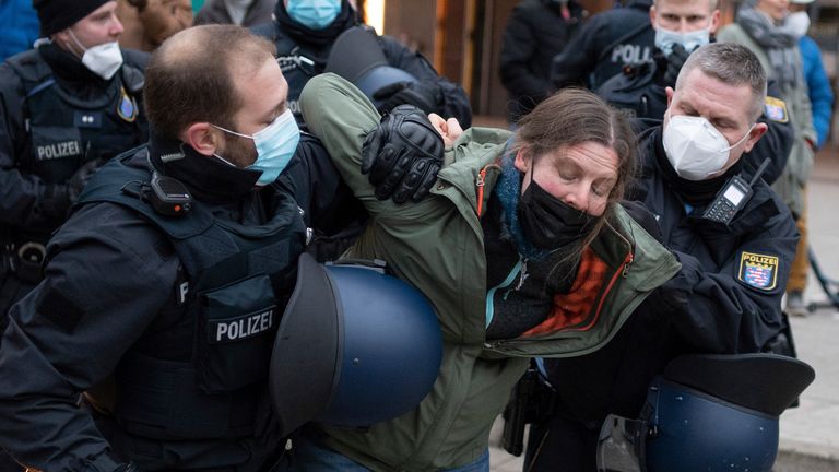 Police detain a protester demonstrating against COVID-19 measures in Frankfurt