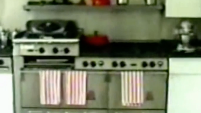 A kitchen was decorated with black and white floor tiles