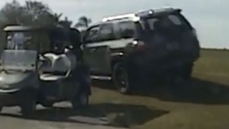 Police chase a motorist across a golf course