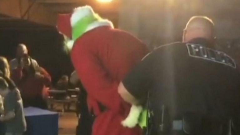 The Grinch being arrested