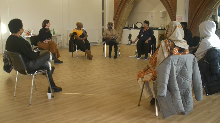 A group of people from ethnic minority backgrounds are gathered to talk about their mental health
