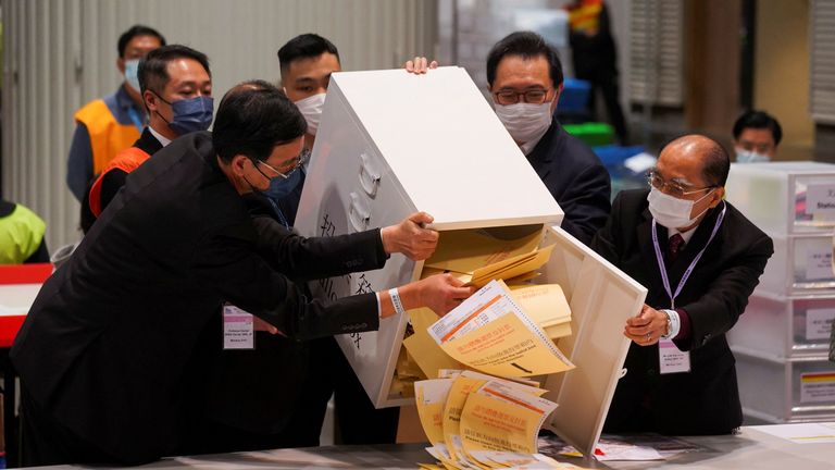 A ballot box being opened by the chairman of the Electoral Affairs Commission, Barnabas Fung Wah, and others