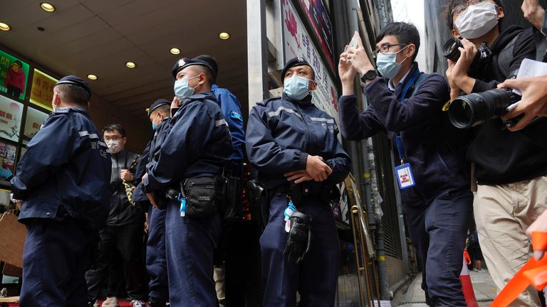 Police officers stand guard outside the offices of Stand News. Pic: Ap