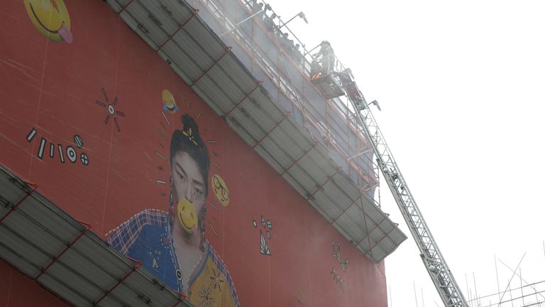 A firefighter rescues people trapped in a fire that broke out at the World Trade Centre in Hong Kong, China, December 15, 2021. REUTERS/Lam Yik
