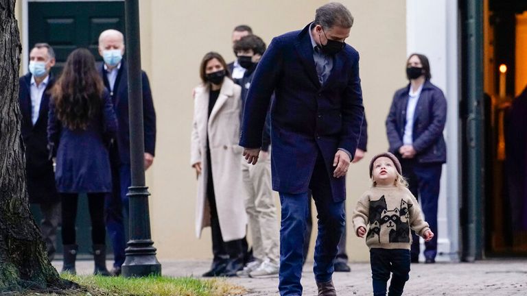 President Joe Biden, third from left, watches as his son Hunter Biden follows his grandson Beau Biden as the family leave St. Joseph on the Brandywine Catholic Church in Wilmington, Del., Saturday, Dec. 18, 2021. Today is the anniversary of Neilia and Naomi Biden&#39;s death. (AP Photo/Carolyn Kaster)