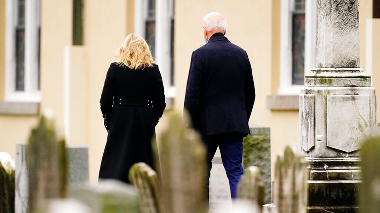 President Joe Biden and First lady Jill Biden walk from St. Joseph on the Brandywine Catholic Church in Wilmington, Del., Saturday, Dec. 18, 2021. (AP Photo/Matt Rourke)