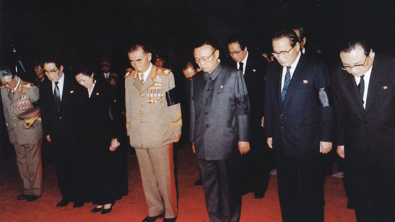 In this July 11, 1994 photo from North Korea&#39;s official Korean Central News Agency, distributed by Korea News Service, Kim Jong Il takes a moment of silence for leader Kim Il Sung in front of his coffin. From the right, Kim Yong Ju, Kang Song Sa, Kim Jong Il, O Chin U, Kim Kyong Hui, Pak Song Chol and Choi Kwang. (Korean Central News Agency/Korea News Service via AP Images)



